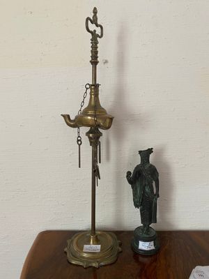 a lamp that is on a table next to a figurine