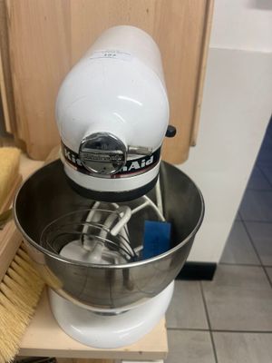 a stand mixer with a bowl and a brush on it