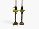 pair of green glass candlesticks sitting on top of each other