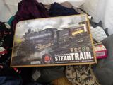 a box with a train on it sitting on a bed