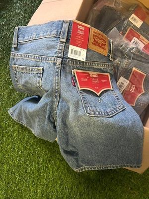 a box of jeans that are sitting on the grass