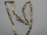 a gold plated necklace with a long chain and a clasp
