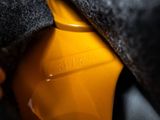 a close up of a person ' s hand holding a yellow gas can