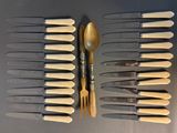 a lot of knives and spoons that are on the table