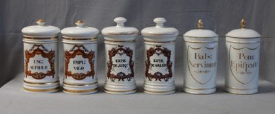 six white and brown canisters with ornate designs on them
