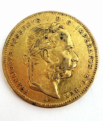 l'image d'une pièce d'or sur laquelle figure le visage d'un homme