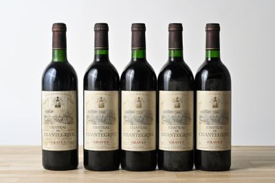 four bottles of wine are lined up on a table