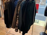 a lot of clothes hanging on a rack in a store