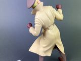 toy figurine of a man in a trench coat with a hat and gloves
