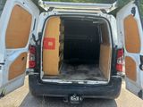 a white van with its doors open in a parking lot