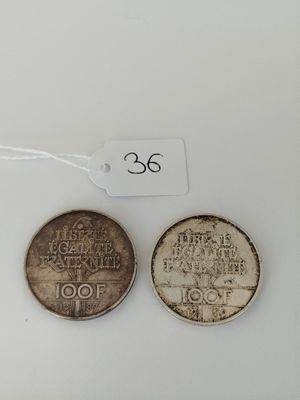 three coins are shown on a white surface with a price tag