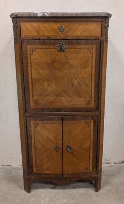 an old wooden cabinet with two doors and a drawer on top of it