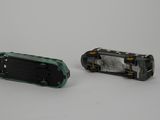 two pieces of metal that have been removed from the back of a toy car