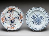 pair of blue and white plates with flowers and birds on them