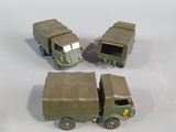 four toy army vehicles that are sitting on a table