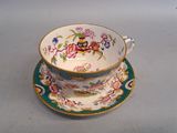 a cup and saucer sitting on a table