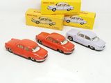 several toy cars are lined up in a row in front of a box