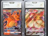 two pokemon cards in plastic cases on a black surface