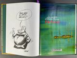 an open book with a picture of a man on a boat