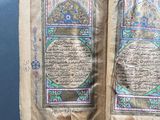 an open book with arabic writing on it sitting on a table