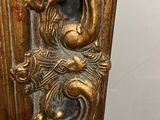 an ornate gold mirror with a dragon on it