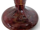 a brown vase with writing on it sitting on a table
