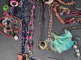 many different necklaces and bracelets laid out on a table