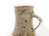 a close up of a coffee mug on a white surface