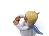 a figurine of an angel holding a baseball glove