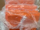 a lot of carrots wrapped in plastic on a box