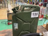 a green jerry can with a hose on the floor
