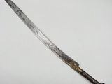 a close up of a knife on a table with a white background