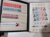 an open book with stamps on it on a table