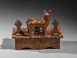 pair of bronze figurines of animals and birds on a table