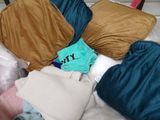 a pile of pillows and blankets on a bed
