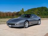 a silver sports car parked on the side of the road