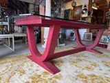 a red table with a glass top in a room
