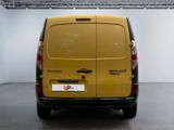 the back of a yellow van parked inside of a building