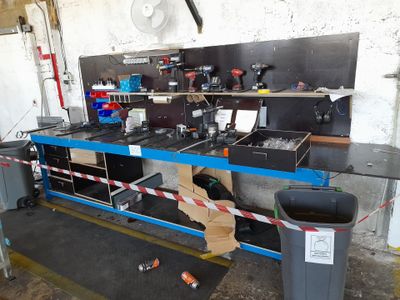 an image of a workbench in a garage with a lot of tools
