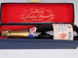 une bouteille de vin dans une boîte bleue posée sur une table