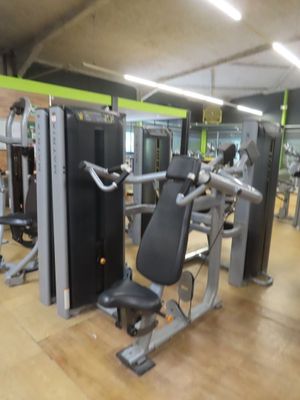 a gym room with a row of machines in it