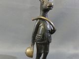 bronze statue of a deer with a bell in its mouth