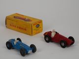 two toy cars sitting next to each other on a table