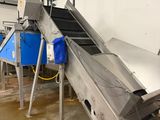 an image of a conveyor belt in a factory with a blue bucket
