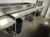a large stainless steel sink in the middle of a kitchen