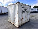 a white container with graffiti on it in a parking lot