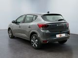 the rear view of a silver car parked in a room