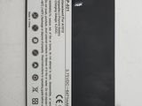 a close up of a cell phone battery on a white surface