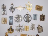 many different types of badges on a white surface