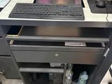 a computer sitting on top of a desk in a room